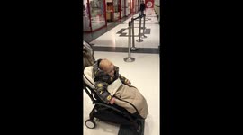 Toddler dancing in pram.
