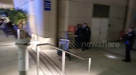 TSA officer allegedly  Assaulted by homeless man at LAX lax airport police arresting the man