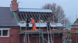 Time lapse of workmen installing a new house roof