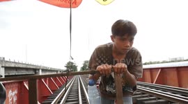 Manila 'trolley boys' use handmade carts to ferry commuters on illegal railway