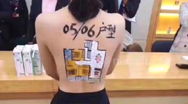 Chinese property developer paints floor plans on topless models in shocking PR stunt