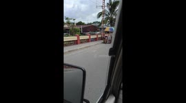 School children help struggling old lady to push her cart up hill