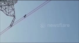 Terrifying moment man risks life walking on high-tension wire in northern India