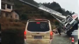 Two men narrowly escape being buried by crane falling over on road