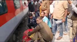 Terrifying moment cop holds on to slipping woman on edge of railway platform for over a minute