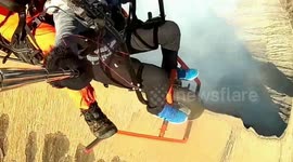 Woman makes daring flight across Indonesian volcanic crater using motorcycle-powered paraglider