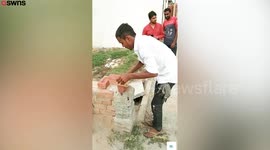 Moment man shows off his bizarre talent for lifting bricks with his TEETH