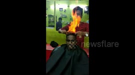 Drop the scissors! Indian barber trims customer's hair by setting it on FIRE