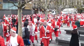 Hundreds of people dressed as Father Christmas at Kings Cross Station London
