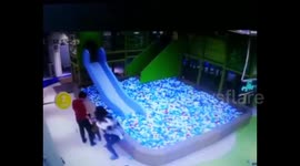 Angry woman throws little girl into ball pit after girl got into fight with her son