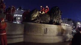 Santa From The Annual Santacon Trys To Get On One Lions In Trafalgar Square