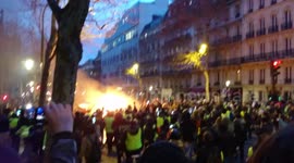 Riots in Paris: several demonstrators sing the national anthem in front of a burning car.