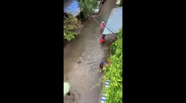 People go fishing in the streets after heavy rains cause flooding in Vietnam