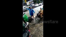 1 hour of heavy rain, a woman was carried away by a rush of water which was swimming in one of the main streets in Malang city, Indonesia
