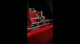 When you're not feeling the party! Girl's glum reaction to fairground ride as others enjoy themselves