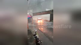 Bus drives through submerged highway during torrential floods in Indonesia