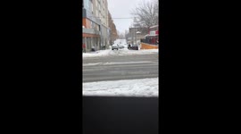 Guy drives in the snow with his windshield still covered