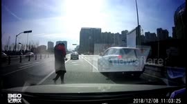 Boy falls out of back of a minibus onto busy road in China