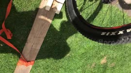 Girl's hilarious fail on wheelie cheat device sends her backward into a hedge