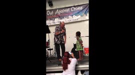 Man sweetly serenades little girl at NYPD 'Night out against crime' event