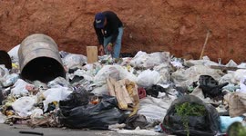 Venezuelan man looking food in the garbage in Caracas