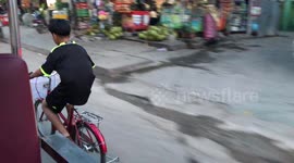 Boy Racing Traffic On His Bike