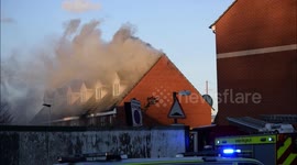 London Fire Brigade using an aerial platform ladder to tackle a house fire in North Woolwich