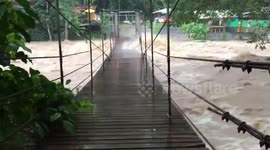 Flash floods batter suspension bridge in southern Thailand
