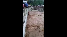 Dramatic moment mother and three children are rescued from raging river in Philippines