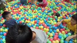 Children excited playing colorful balls