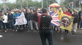 Sriwijaya fc supporters face the player's bus to express love at the Palembang club