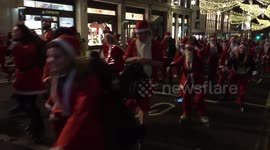 Skating Santas stream through central London