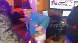 Drunk guy dancing in underwear at Christmas party.
