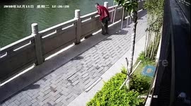 Shocking moment as Chinese man kicks cat into river