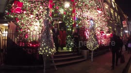 Two women on stilts dress as Christmas trees