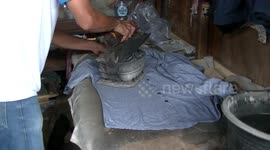 Traditional Indonesian laundry uses heated coconut charcoal to iron clothes
