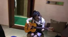 North korean girl borrows my guitar and sings a korean song. October 2018.