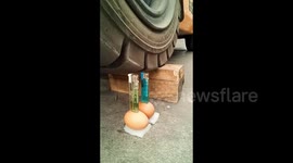 Man delicately drives a forklift to light lighters placed on eggs