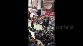 Staff dance at airport stall to keep up morale during delays