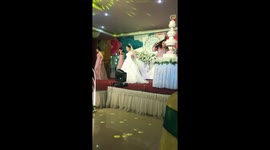 Bride and bridesmaids do choreographed dance for groom at Vietnam wedding