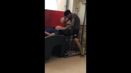 Barber performs kungfu when shampooing guests in the hair salon.