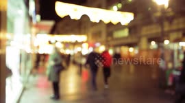 a holiday atmosphere on the street that is surrounded by New Year's lighting
