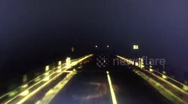 Road disappears under flood water as a truck tries to cross to get feed to stranded animals