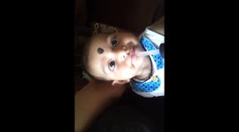 baby tasting pomegranate juice