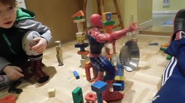 Boys funny reaction playing with Spiderman toy