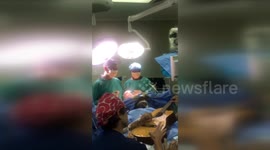 LONGER VERSION: Musician plays guitar during brain surgery in South Africa
