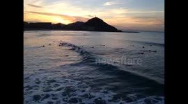 Surfers take advantage of warm weather in San Sebastian / Donostia in the Basque Country of Spain