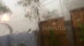 Sparks fly from power line during storm in Brisbane, Australia