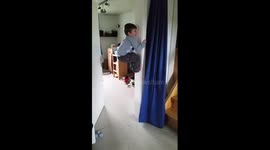 Boy climbs doorframe like a koala