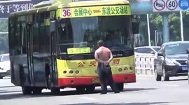 Drunk topless man holds up bus in China